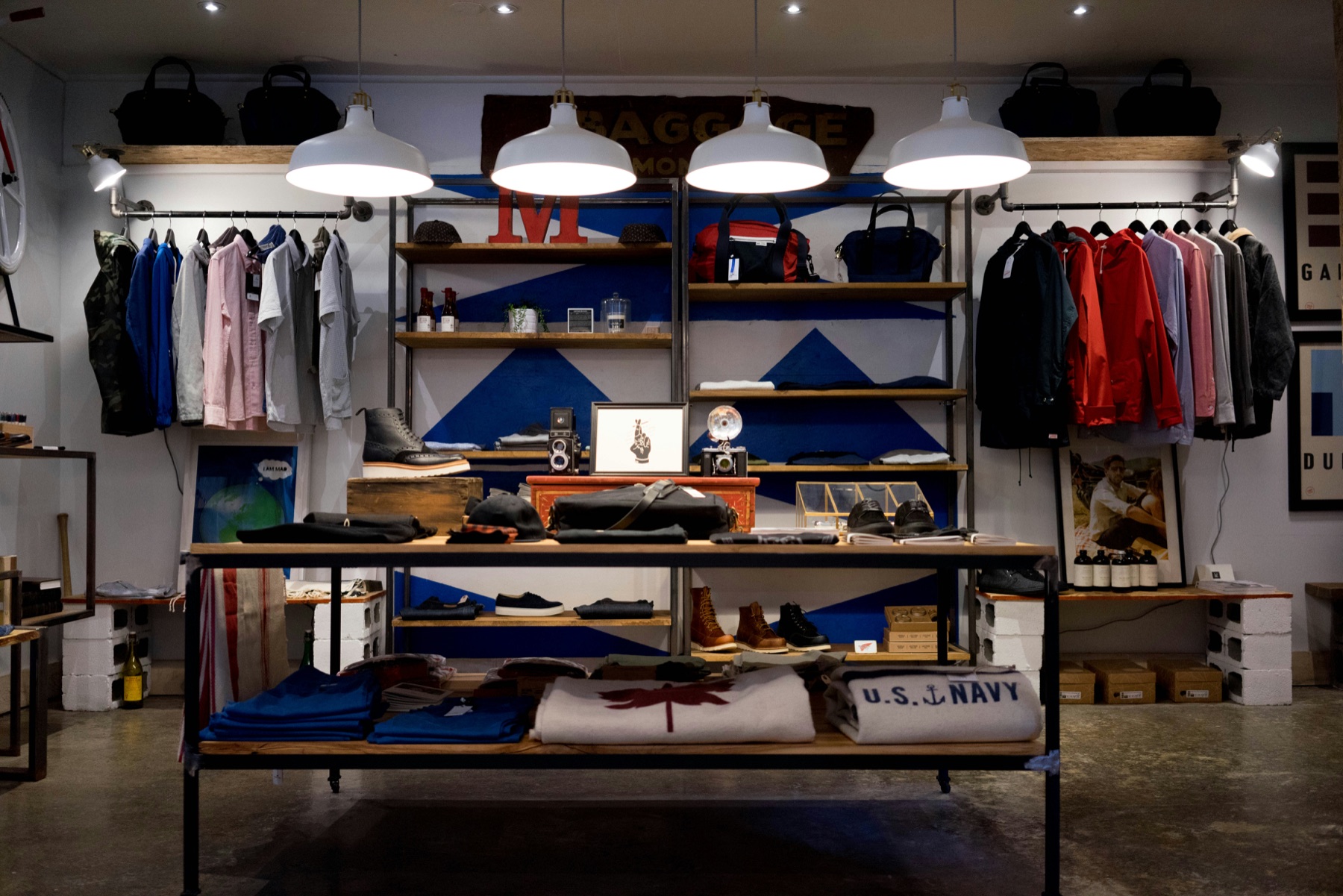 Curated apparel, footwear, and accessories merchandised on industrial shelving inside a modern Shopify retail store